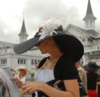 Colleen Rice, of Louisville, Ky., reads a race program in the paddock area during the 134th Kentucky Derby Saturday, May 3, 2008, at Churchill Downs in Louisville, Ky.  (AP Photo/Patti Longmire)